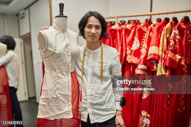 male qun gua designer standing next to dressmaker’s model - dressmaker's pattern stock pictures, royalty-free photos & images