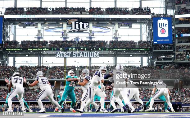 Dak Prescott of the Dallas Cowboys hands the ball off to Ezekiel Elliott of the Dallas Cowboys in action against the Miami Dolphins in the first half...