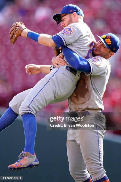 Todd Frazier of the New York Mets and Pete Alonso also of the Mets celebrate afer defeating the Cincinnati Reds at Great American Ball Park on...