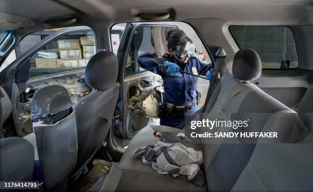 Customs and Border Protection agent searches an automobile for contraband in the line to enter the United States at the San Ysidro Port of Entry on...