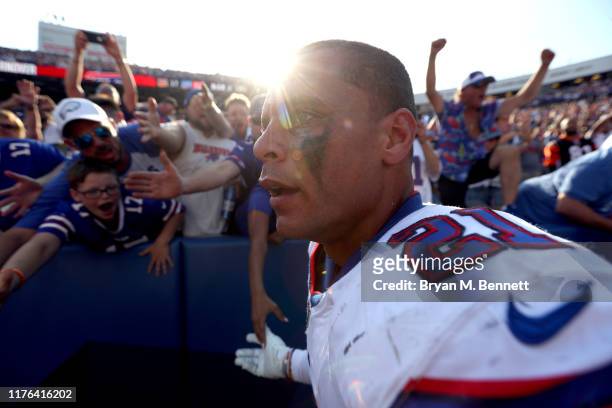 Jordan Poyer of the Buffalo Bills slaps hands with fans during a game against the Cincinnati Bengals at New Era Field on September 22, 2019 in...