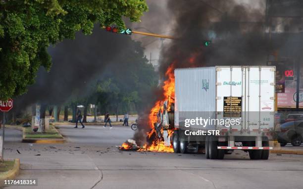 Truck burns in a street of Culiacan, state of Sinaloa, Mexico, on October 17, 2019. Heavily armed gunmen in four-by-four trucks fought an intense...