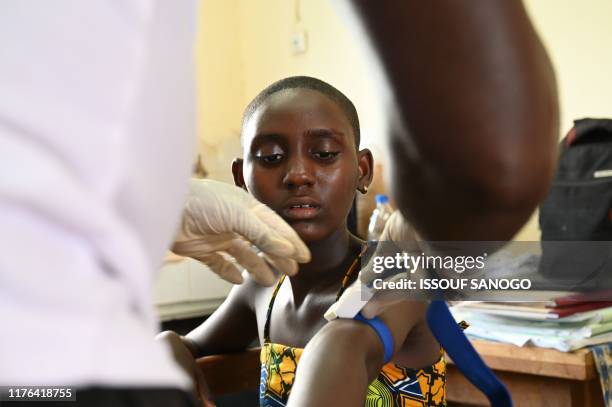 Prisca Dali who was diagnosed with Human African Trypanosomiasis after being ill for 4 years, has her blood drawn during an Human African...