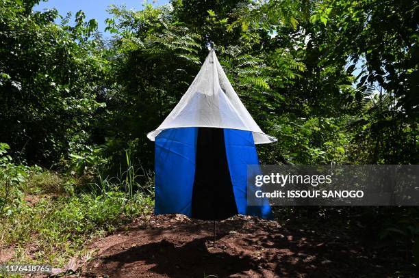 Tsetse fly trap, made out of blue screens that contains insecticide, is set by Pierre Richet Institute workers to eliminate Human African...