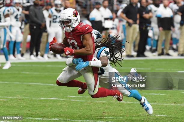 Christian Kirk of the Arizona Cardinals attempts to make a diving catch while being defended by Tre Boston of the Carolina Panthers during the first...