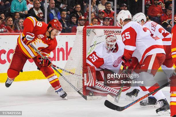 Matthew Tkachuk of the Calgary Flames attempts a wrap-around shot on Jimmy Howard of the Detroit Red Wings at Scotiabank Saddledome on October 17,...