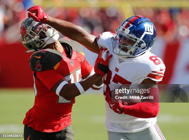Wide receiver Sterling Shepard of the New York Giants stiff-arms cornerback Sean Murphy-Bunting of the Tampa Bay Buccaneers during the game at...