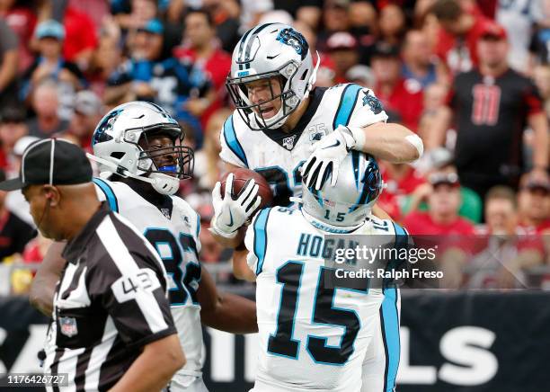 Running back Christian McCaffrey of the Carolina Panthers celebrates with teammates Chris Manhertz and Chris Hogan of the Panthers after his 76-yard...