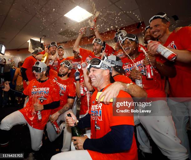 The Houston Astros celebrate winning the American League West Division after defeating the Los Angeles Angels at Minute Maid Park on September 22,...