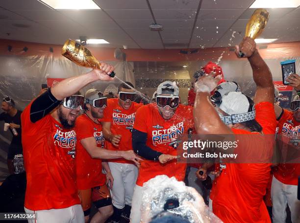 The Houston Astros celebrate winning the American League West Division after defeating the Los Angeles Angels at Minute Maid Park on September 22,...