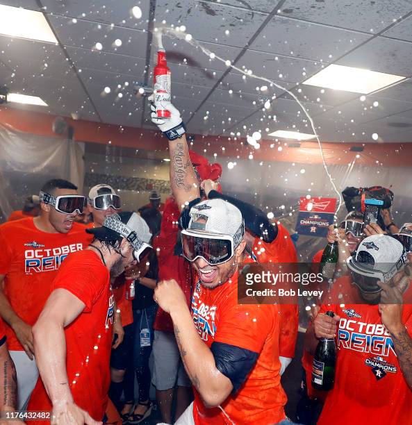 The Houston Astros celebrate winning the American League West Division after defeating the Los Angeles Angels at Minute Maid Park on September 22,...