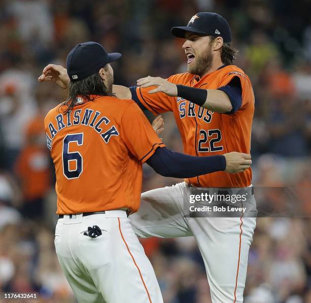 Jake Marisnick of the Houston Astros and Josh Reddick celebrate after winning the American League West Division after defeating the Los Angeles...