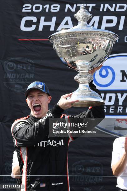 Josef Newgarden of United States and Hitachi Team Penske Chevrolet celebrates with the Astor Cup after winning the NTT IndyCar Series championship...