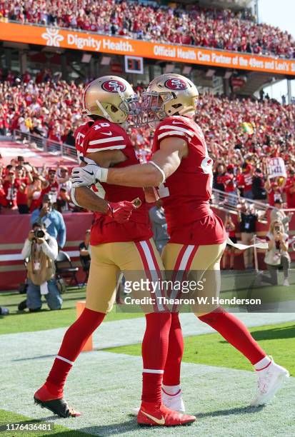 Dante Pettis and Kyle Juszczyk of the San Francisco 49ers celebrates after Pettis caught a touchdown pass late in the fourth quarter against the...