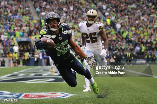 Tyler Lockett of the Seattle Seahawks reaches for an incomplete pass against the New Orleans Saints in the fourth quarter during their game at...