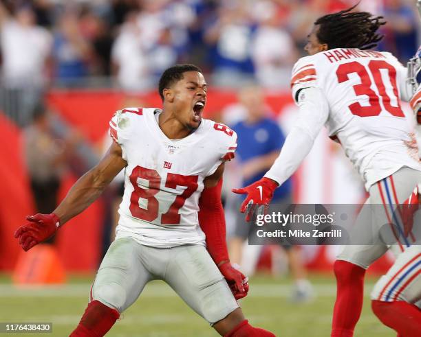 Wide receiver Sterling Shepard and cornerback Antonio Hamilton of the New York Giants celebrate after a missed field goal attempt by the Tampa Bay...