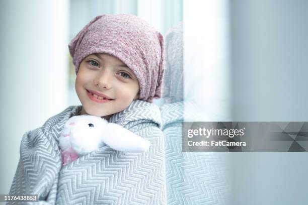 portrait of a girl with cancer holding a stuffed toy - cancer illness stock pictures, royalty-free photos & images