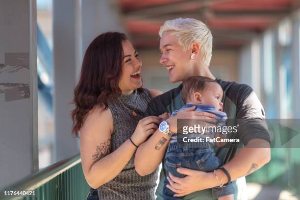 young lgbt family spending time together - fat lesbian stock pictures, royalty-free photos & images