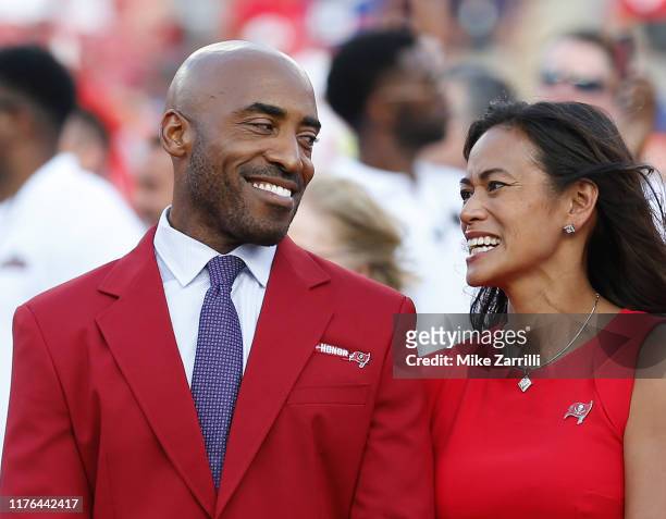 Former Tampa Bay Buccaneers defensive back Ronde Barber talks with his wife, Claudia, during the halftime Ring of Honor ceremony in his honor during...