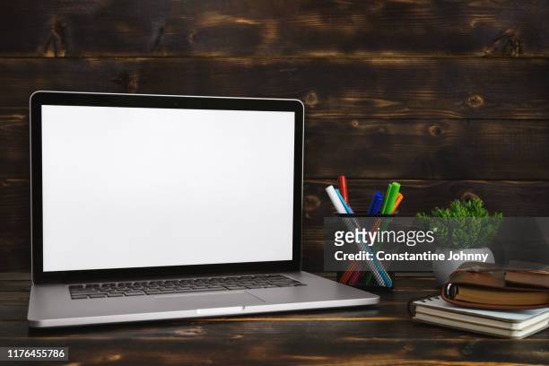 laptop with blank white screen against rustic wood background. screen mock up. - wood desk ストックフォトと画像