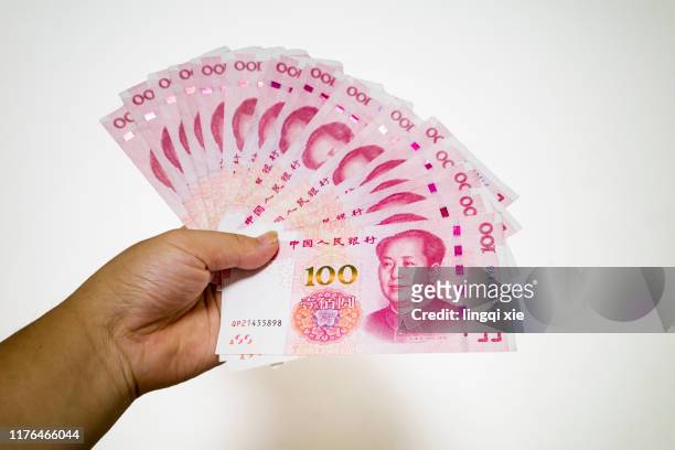 he had a pile of 100 yuan rmb in his hand. - images of chinese yuan banknotes stock pictures, royalty-free photos & images