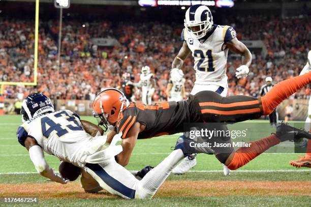 Strong safety John Johnson of the Los Angeles Rams makes an interception on a pass intended for wide receiver Damion Ratley of the Cleveland Browns...