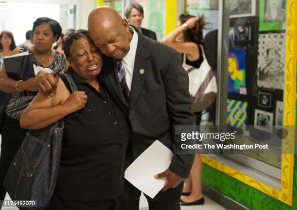 Rep. Elijah E. Cummings, D-MD, receives a hug after autographing a photograph for Roslyn Gomez at Woodlawn Senior High School in Gwynn Oak, Maryland...
