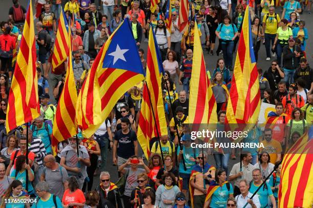 Pro independence protesters march along a highway in San Vicenc dels Horts, on October 18 on the day that separatists have called a general strike...