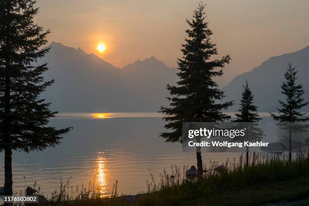Sunset over Lake Crescent in Lake Clark National Park and Preserve, Alaska, USA, with smoke in the air from wildfires in Alaska.