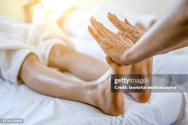 foot massage in spa salon - reflexology stock pictures, royalty-free photos & images