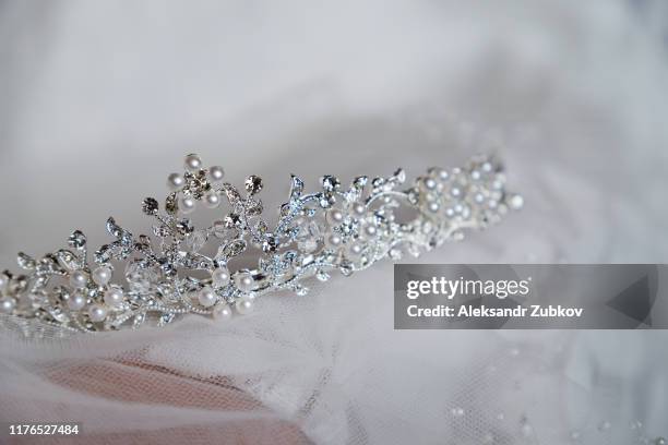 beautiful bride's crown is on the veil, close-up. wedding day. morning bride. - beauty pageant crown stock-fotos und bilder