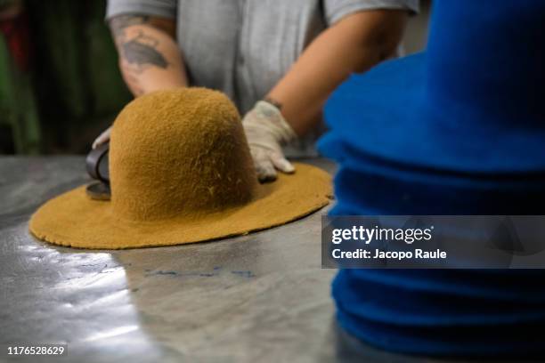 The Borsalino artisan works at one of 52 manual steps of production on July 31, 2019 in Spinetta Marengo, Italy. Manifattura Borsalino is an Italian...