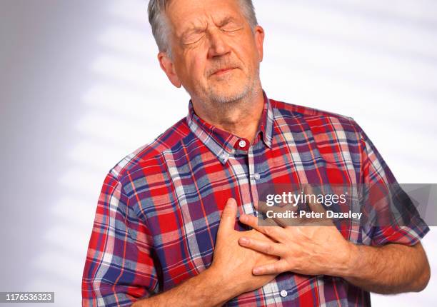 senior man clutching heart in pain - cardiac arrhythmia stock pictures, royalty-free photos & images