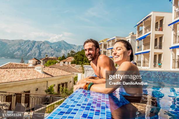 young couple have fun in a pool - summer spa stock pictures, royalty-free photos & images