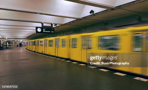 train leaving platform inside berlin subway station - berlin subway stock pictures, royalty-free photos & images