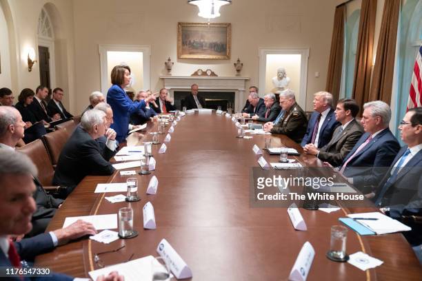 In this handout provided by the White House, U.S. President Donald Trump meets with House Speaker Nancy Pelosi and Congressional leadership in the...