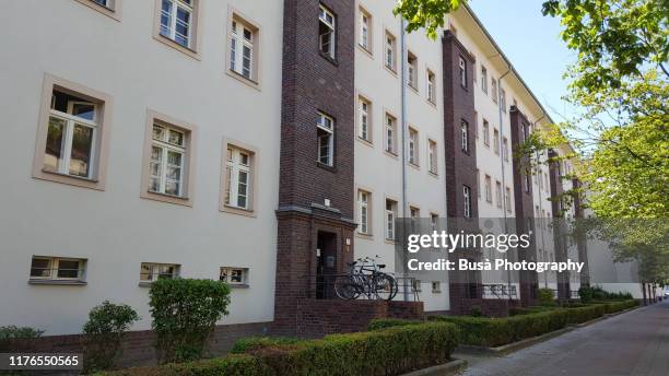 facade of residential housing in east berlin, germany - housing development stock-fotos und bilder