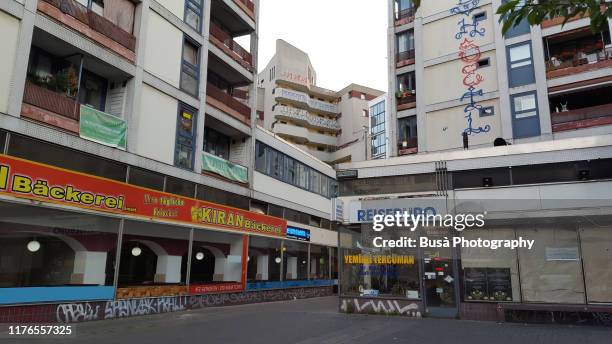 buildings near kottbusser tor in the district of kreuzberg in berlin, germany - berlin graffiti stock-fotos und bilder