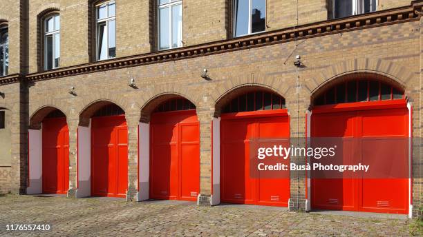 red painted gates of fire department station in the oderbergerstrasse in berlin, district of prenzlauerberg - fire station ストックフォトと画像