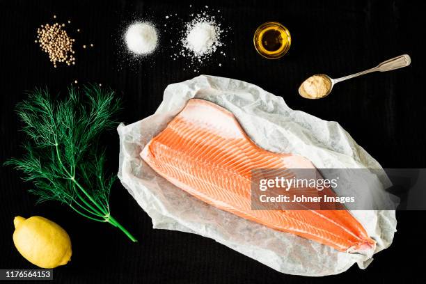 ingredients for baked salmon on black background - dill stock pictures, royalty-free photos & images
