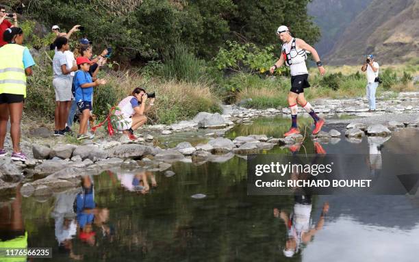 Runner competes in the Grand Raid de la Reunion ultramarathon race on October 17, 2019 in the Cirque de Mafate caldera on the French Indian ocean...