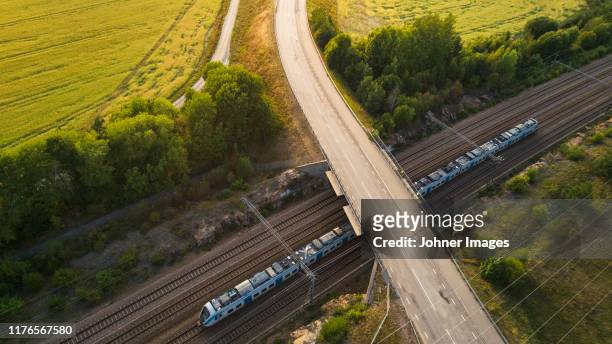 train on tracks, aerial view - büro bäume nacht stock-fotos und bilder