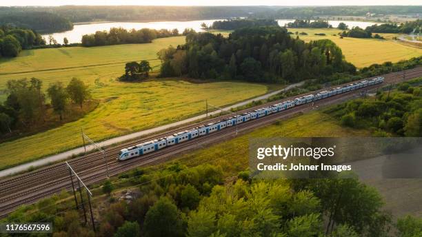 train on tracks, aerial view - büro bäume nacht stock-fotos und bilder