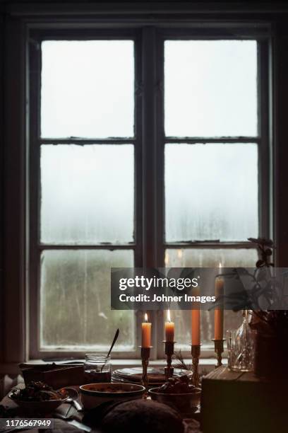 candles on windowsill - candle holder stock pictures, royalty-free photos & images