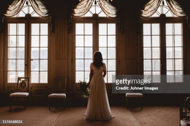 bride looking through window - västra götaland county stock-fotos und bilder