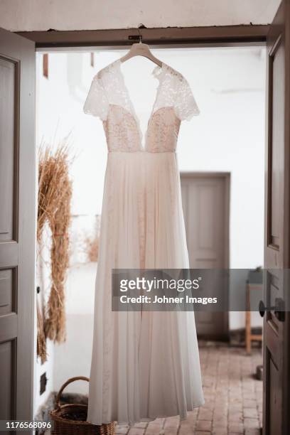 wedding dress hanging - wedding dress stockfoto's en -beelden