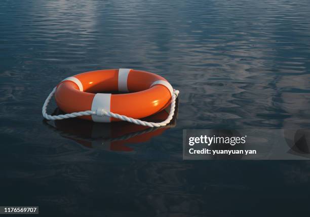 life buoy on the water - rettungsring stock-fotos und bilder