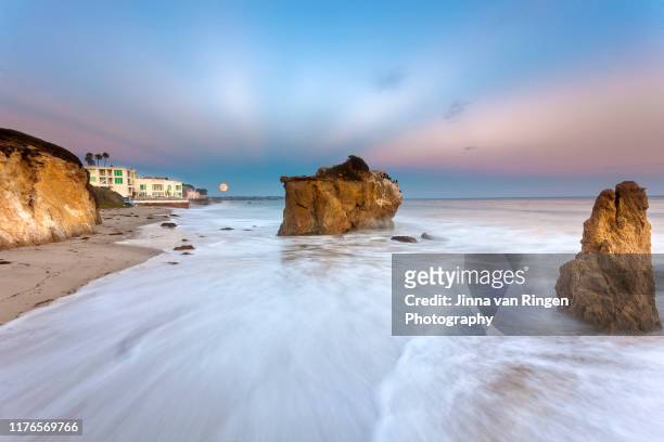 long exposure of full moon rising over el matador state beach california - malibu beach california stock pictures, royalty-free photos & images