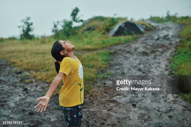 girl enjoying rain - enjoy monsoon stock-fotos und bilder