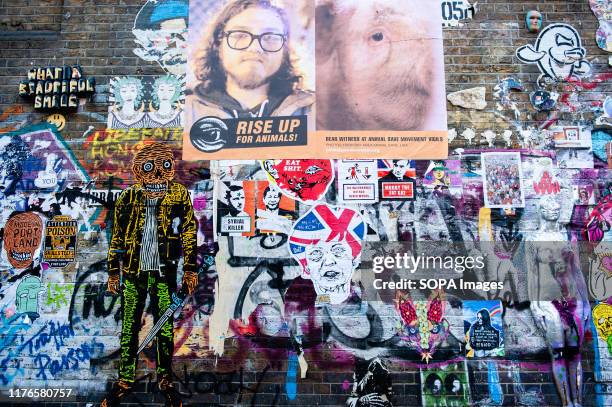 View of a wall filled with political posters. As the Brexit deadline looms, new murals and paste-ups appear on the streets of London. Brick Lane, in...